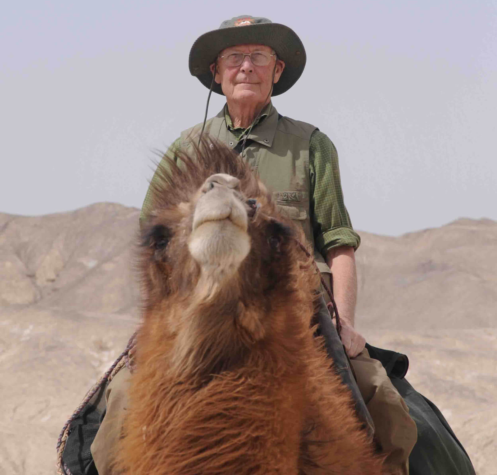 John Hare, mounted on a Bactrian camel, 2011 expedition Desert of Lop, China
